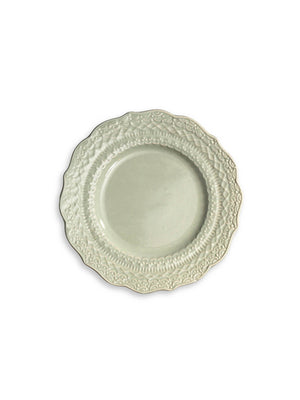 The Verdant Plate Range features round, white ceramic plates with ornate embossed floral and scroll patterns along scalloped edges, evoking vintage-inspired charm, shown on a plain white background.