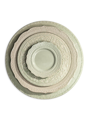 The Verdant Plate Range includes four vintage-inspired plates in assorted sizes, each with ornate embossed patterns and scalloped edges, finished in soft pastel green and beige tones.
