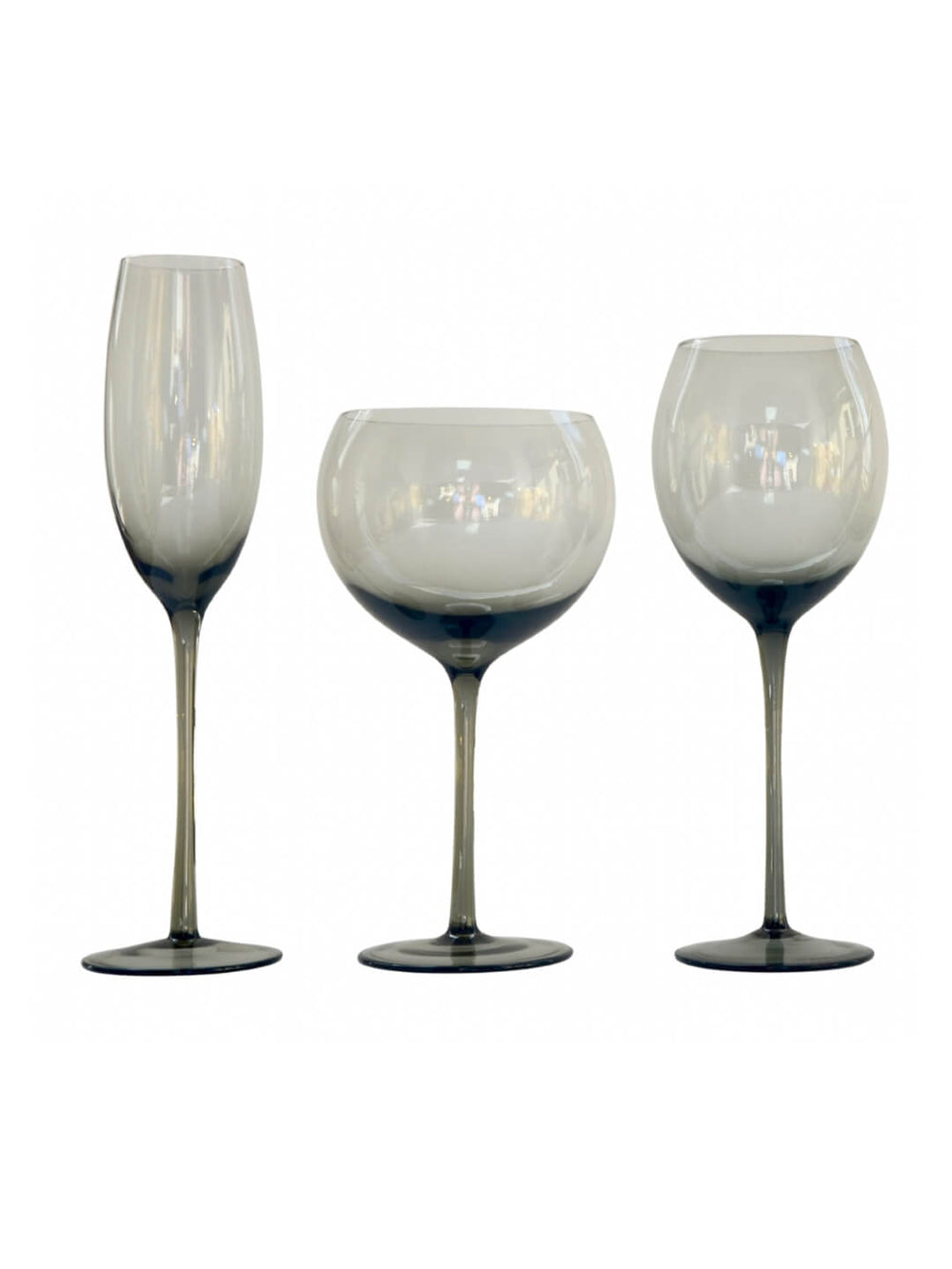 Three elegant styles from the Vita Smoke Glassware Range feature smoky, translucent glass with dark stems, displayed side by side on a white background—a sophisticated touch for any modern table setting.