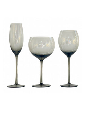 Three elegant styles from the Vita Smoke Glassware Range feature smoky, translucent glass with dark stems, displayed side by side on a white background—a sophisticated touch for any modern table setting.