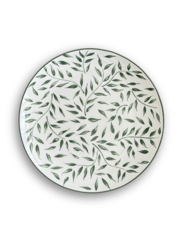 The Willow Plate Range features a round white plate with a green leafy vine pattern, shown from above on a plain white background for an elegant botanical look.