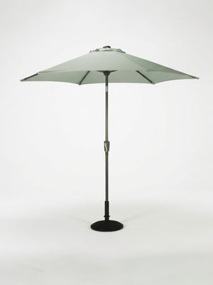 The Amalfi Parasol from the Colourful Parasol Collection is a large, light green round patio umbrella with weather-resistant design, mounted on a dark pole with black base, shown against a white background. Ideal for outdoor event shade.