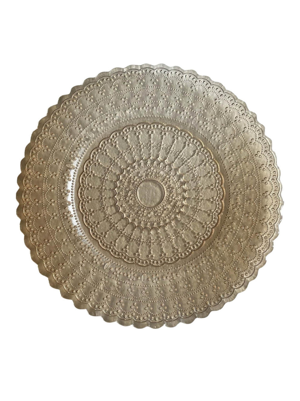 The Antoinette Champagne Charger Plate is a round, ornate silver metal tray featuring intricate engraved patterns and a scalloped edge, evoking vintage glamour against a white background.