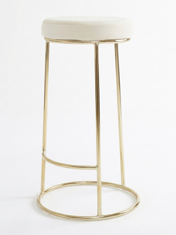 The Astor Bar Stool features a modern design with a round white cushioned seat and a gold metal frame with four legs and circular supports.
