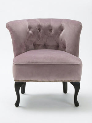 The Cameo Chair is a vintage-style accent chair in lavender velvet, featuring a tufted backrest, curved design, and dark wooden cabriole legs, shown against a plain white background.
