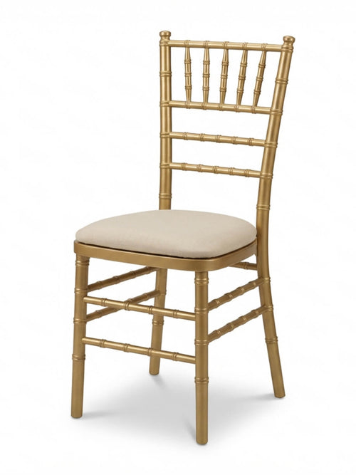 The Chiavari Chair - Gold features a cushioned beige seat and decorative spindle backrest, ideal for elegant events. Custom seat pads are available for extra comfort and style.