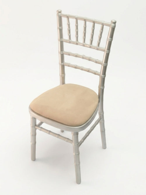 The Chiavari Chair - Silver, featuring a cushioned beige seat pad, is ideal for event seating and shown here against a plain white background.