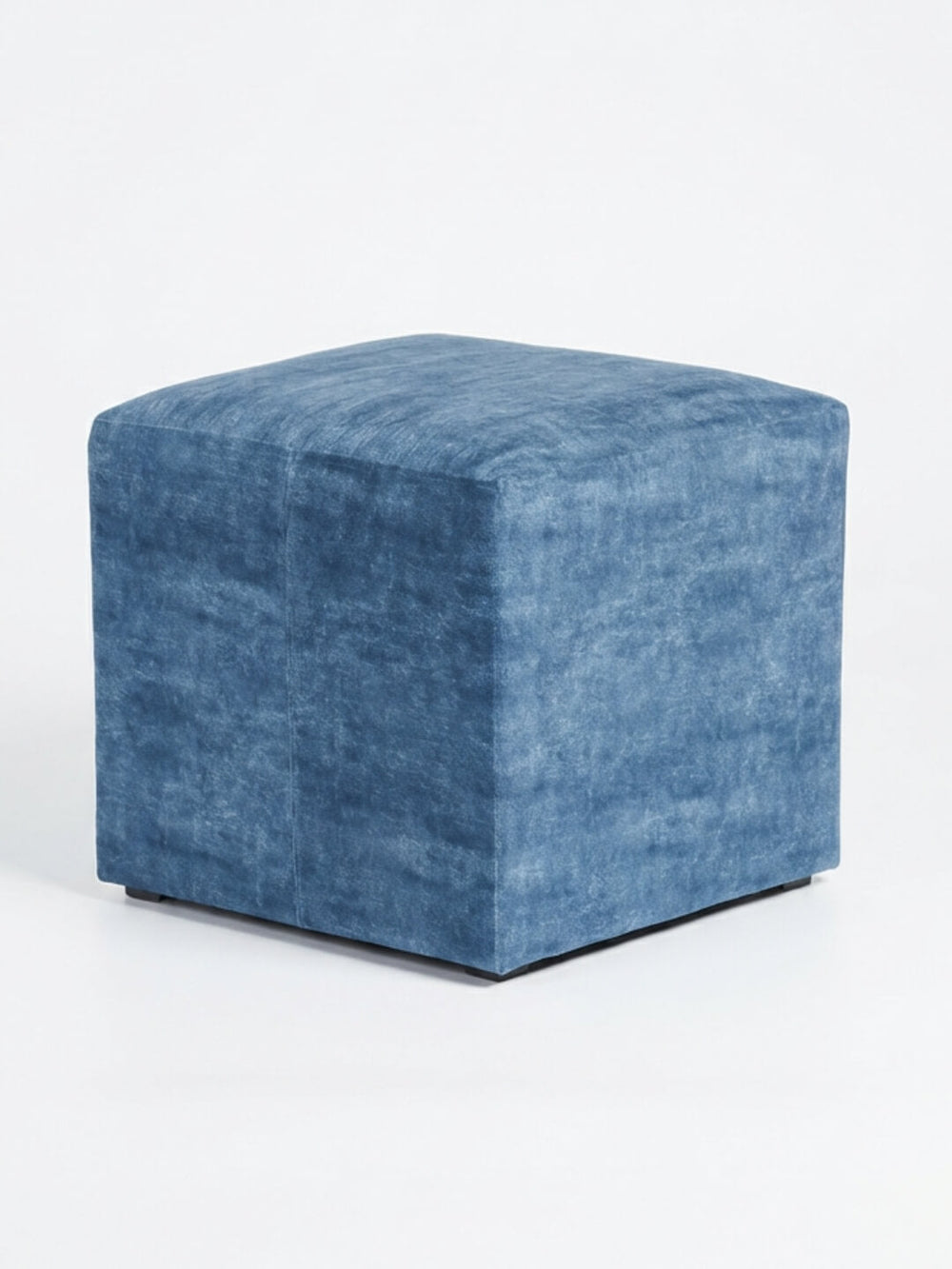 The Coast Cube, a blue velvet ottoman with soft, textured fabric, adds modern charm as a cube seat against a plain white background.