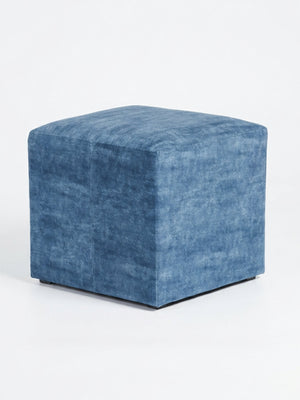 The Coast Cube, a blue velvet ottoman with soft, textured fabric, adds modern charm as a cube seat against a plain white background.