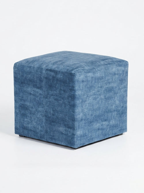 The Coast Cube, a blue velvet ottoman with soft, textured fabric, adds modern charm as a cube seat against a plain white background.