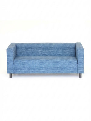 The Coast Sofa is a modern blue velvet piece with square arms and black legs, showcased against a plain white background.