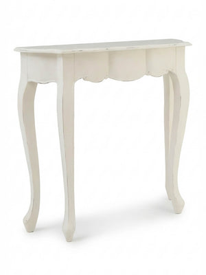 The Colette Console Table is a small, white table with curved legs and scalloped front detailing, adding Parisian elegance to any space.