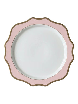The Colette Pink Charger Plate is a round, white luxury plate with a scalloped edge, featuring a wide pink border and a thin gold rim that outlines its wavy shape.