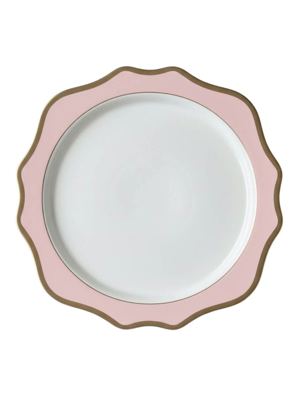 The Colette Pink Charger Plate is a round, white luxury plate with a scalloped edge, featuring a wide pink border and a thin gold rim that outlines its wavy shape.