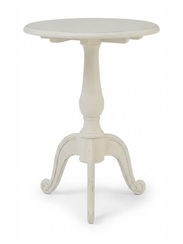 The Colette Side Table is a compact, round table with a central pedestal and three curved legs, finished in distressed white for a vintage Parisian charm.