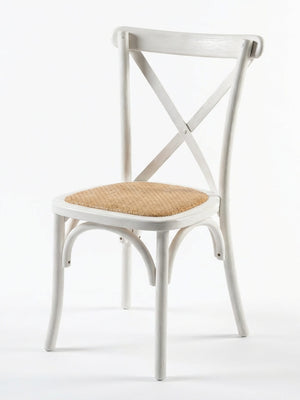 The Cross Back Chair features a curved backrest, X-shaped design, and light brown woven rattan seat—perfect for wedding chair hire or rustic event furniture. Shown here in white against a plain background.