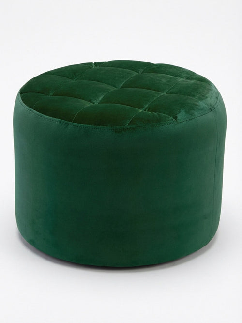 The Eden Pouffe, a round green velvet piece with a quilted and tufted top, is shown on a plain white background.