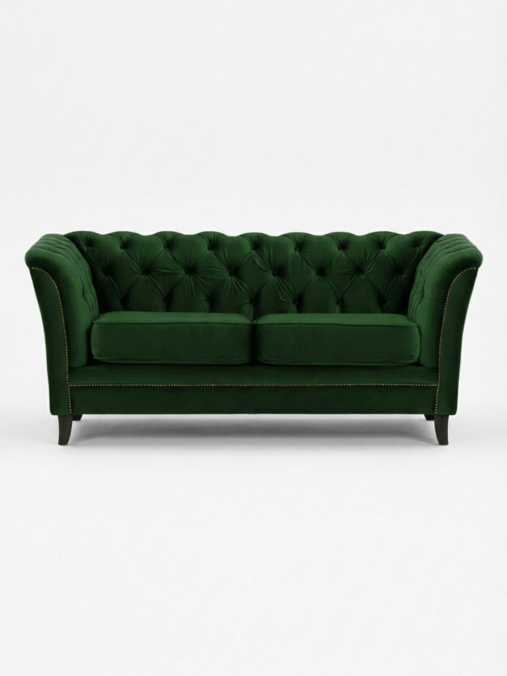 The Eden Sofa, upholstered in dark green velvet with tufted details, curved arms, two seat cushions, and dark wooden legs, offers a touch of modern luxury to any space.