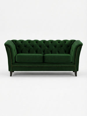 The Eden Sofa, upholstered in dark green velvet with tufted details, curved arms, two seat cushions, and dark wooden legs, offers a touch of modern luxury to any space.