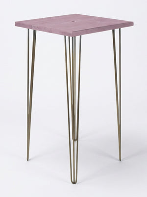 A compact square bar table from the Hairpin Bar Table Collection, featuring a light purple wooden top and slim gold hairpin legs—ideal as colorful event furniture against a plain white backdrop.