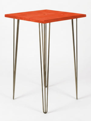 The Hairpin Bar Table Collection offers a modern bar table with a bright red square wooden top and four slender metal hairpin legs—an eye-catching choice for colourful event furniture against plain white backgrounds.