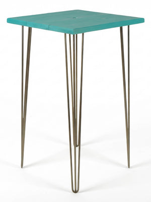 A modern bar table from the Hairpin Bar Table Collection, showcasing a vibrant square teal top and four sleek metal hairpin legs, set against a plain white background.