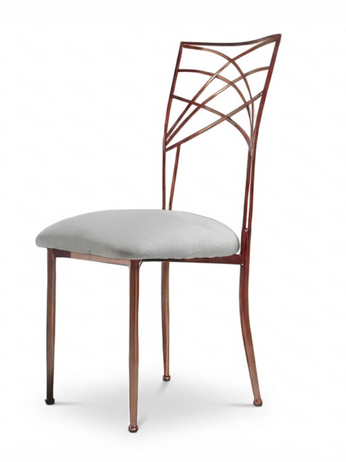 The Lattice Chair features slender legs, a geometric backrest, and a light gray cushioned seat—ideal for modern events—and is displayed against a plain white background.