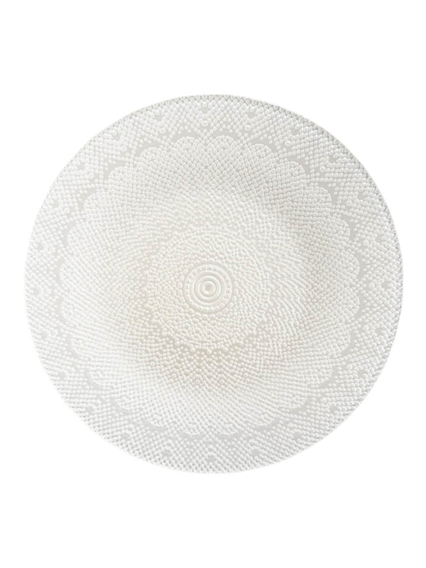 The Lucie Charger Plate is a round, white design with an intricate textured pattern of concentric circles and lace-like details—ideal for elegant wedding table decor.