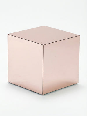 A rose gold metallic cube table from the Luxe Cube Collection rests on a white background, its reflective surfaces catching light—an elegant choice for event furniture.