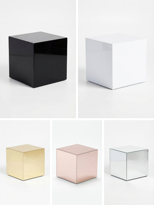 The Luxe Cube Collection features five glossy cube tables in black, white, gold, rose gold, and silver arranged in a grid on a white background—ideal for enhancing any event furniture setup.
