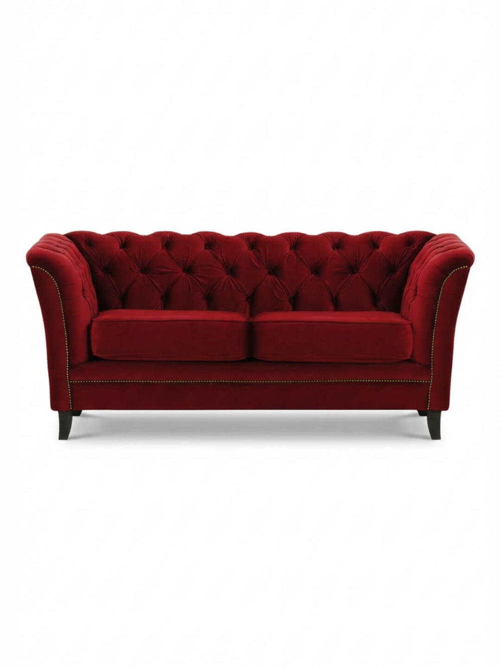 The Merlot Sofa is a luxurious red velvet piece featuring a tufted backrest, flared arms, gold nailhead trim, and four dark wooden legs for a vintage glamour look.