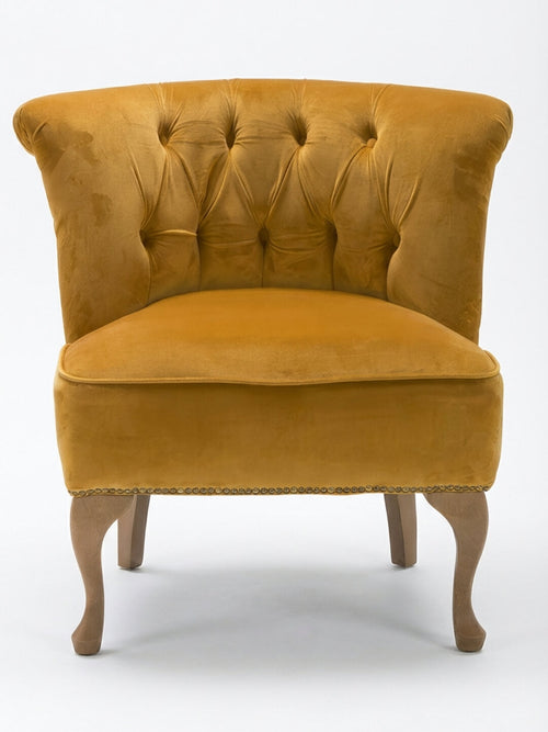 The Midas Chair, a vintage accent piece in mustard yellow velvet with a tufted backrest, curved wooden legs, and decorative trim, is displayed against a plain white background.