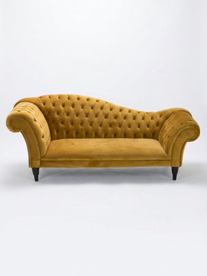 A mustard yellow Midas Sofa with a tufted back, rolled arms, and dark wood legs is shown against a plain white background.