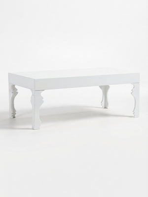 The Muse Blanc Coffee Table features a sculptural white design with intricate, curved legs and a smooth, flat top, beautifully displayed against a plain white background.