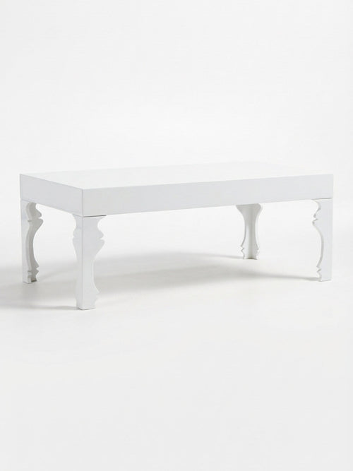 The Muse Blanc Coffee Table features a sculptural white design with intricate, curved legs and a smooth, flat top, beautifully displayed against a plain white background.