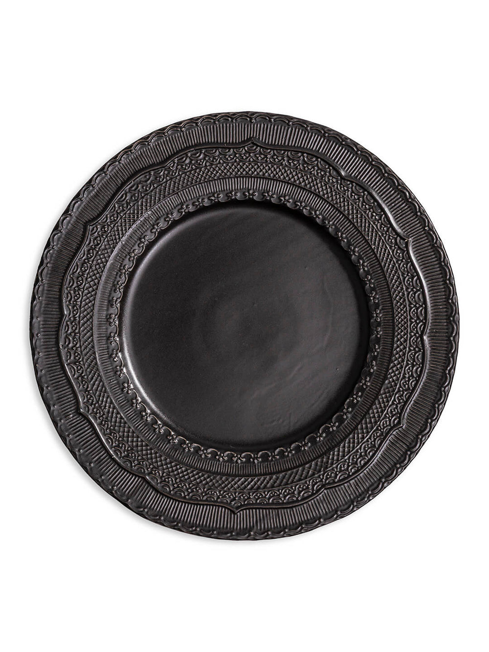 The Noir Charger Plate is a round, dark ceramic plate featuring a glossy finish and intricate raised patterns on its wide rim, ideal for luxurious tablescapes.