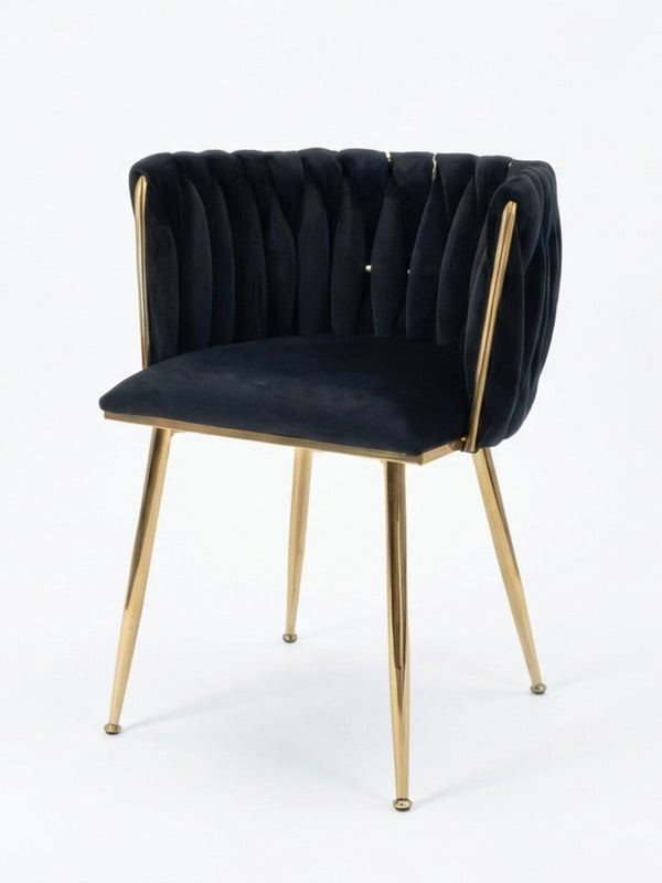 The Noir Signature Chair boasts a black tufted velvet backrest and seat, accented by slim gold metal legs and frame, all set against a plain white background—a modern luxury piece that redefines elegance.