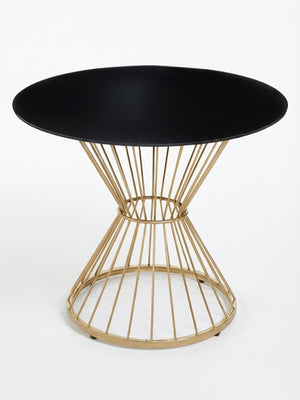 The Orbit Table showcases a sleek black glass top and an eye-catching geometric gold wire base, offering a modern touch ideal for contemporary interiors.