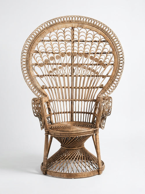 The Peacock Chair features a tall, ornate design with a large rounded backrest, intricate woven patterns, curved armrests, and a circular seat, shown here against a plain white background.