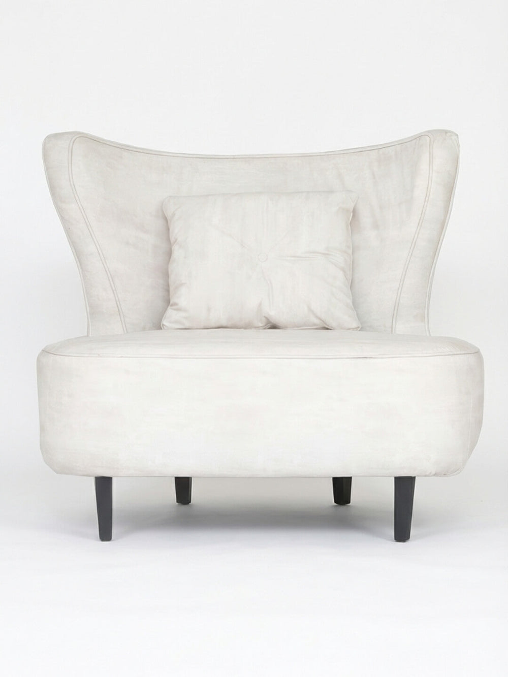 The Pearl Chair is a modern accent chair in light beige, featuring a winged backrest, matching square cushion, and dark wooden legs.