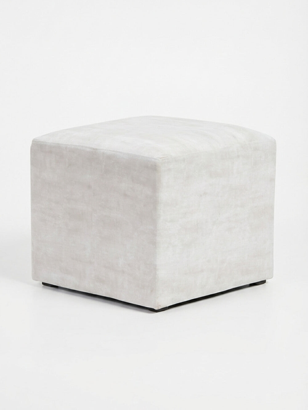 The Pearl Cube is a square ivory velvet ottoman with smooth fabric and a minimalist modern design, ideal for event seating, shown against a plain white background.