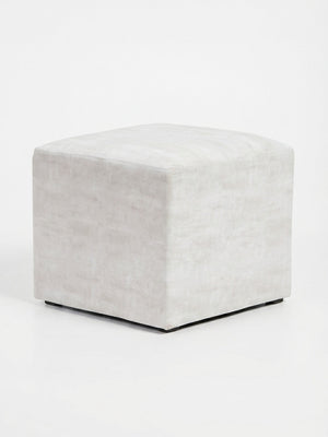 The Pearl Cube is a square ivory velvet ottoman with smooth fabric and a minimalist modern design, ideal for event seating, shown against a plain white background.