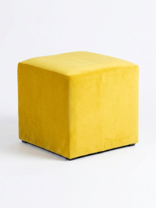 The Radiance Cube, a gold velvet ottoman with a smooth upholstered surface, sits on a white background—an ideal modern accent seat for any space.