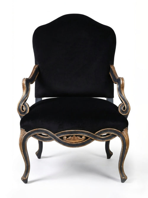 The Rococo Noir Chair features a black velvet seat, high rounded back, ornate carved wooden frame, and curved arms and legs, capturing French palace elegance against a white backdrop.