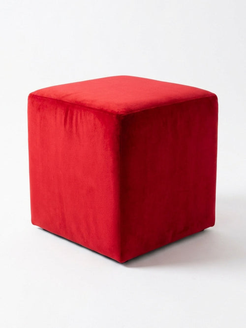 The Rouge Cube, a red velvet ottoman, stands out as modern lounge furniture on a white background—ideal for stylish accent seating.