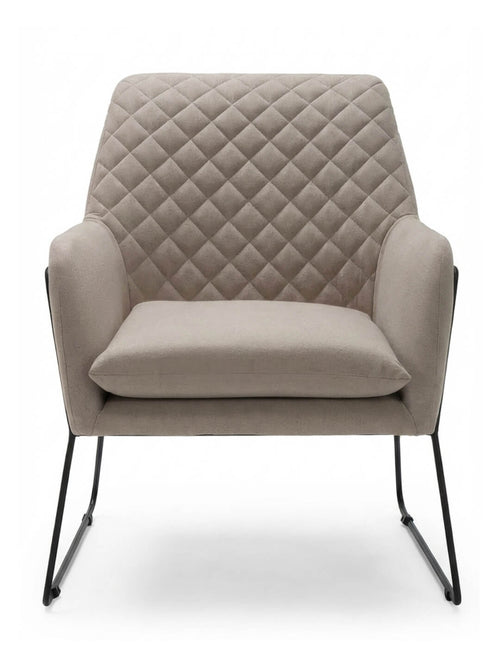 The Sandstone Chair is a modern accent chair with quilted, diamond-patterned beige linen upholstery, a wide cushioned seat, and sleek black metal legs, displayed from the front against a plain white background.