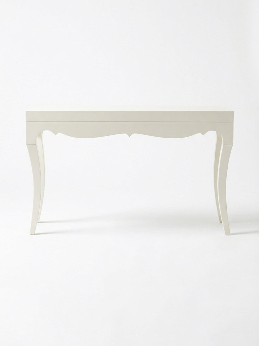 The Savoy Console Table showcases curved legs and a scalloped apron, offering modern glamour in a high-gloss white finish set against a plain white background.