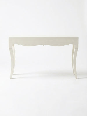 The Savoy Console Table showcases curved legs and a scalloped apron, offering modern glamour in a high-gloss white finish set against a plain white background.