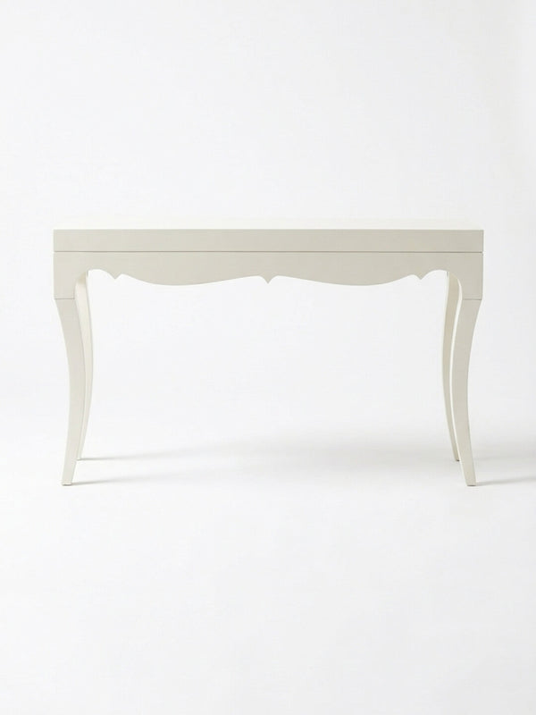 The Savoy Console Table showcases curved legs and a scalloped apron, offering modern glamour in a high-gloss white finish set against a plain white background.