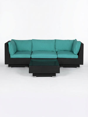 The Sereno Black modular outdoor rattan sofa set features teal cushions and a matching low square coffee table, ideal for contemporary spaces and shown against a plain white background.